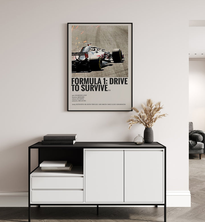 Formula 1-Drive To Survive 2019 Movie Posters in Black Plain Frame placed on a white wall behind a black and white table