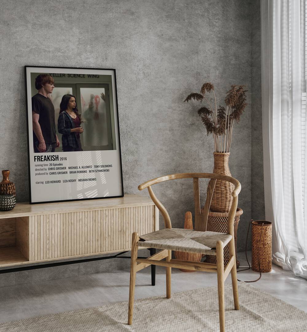 Freakish 2016 Movie Posters in Black Plain Frame placed on a console behind a chair