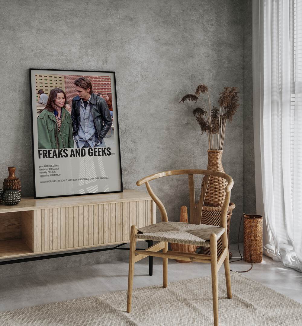 Freaks And Greaks Movie Posters in Black Plain Frame placed on a console behind a chair