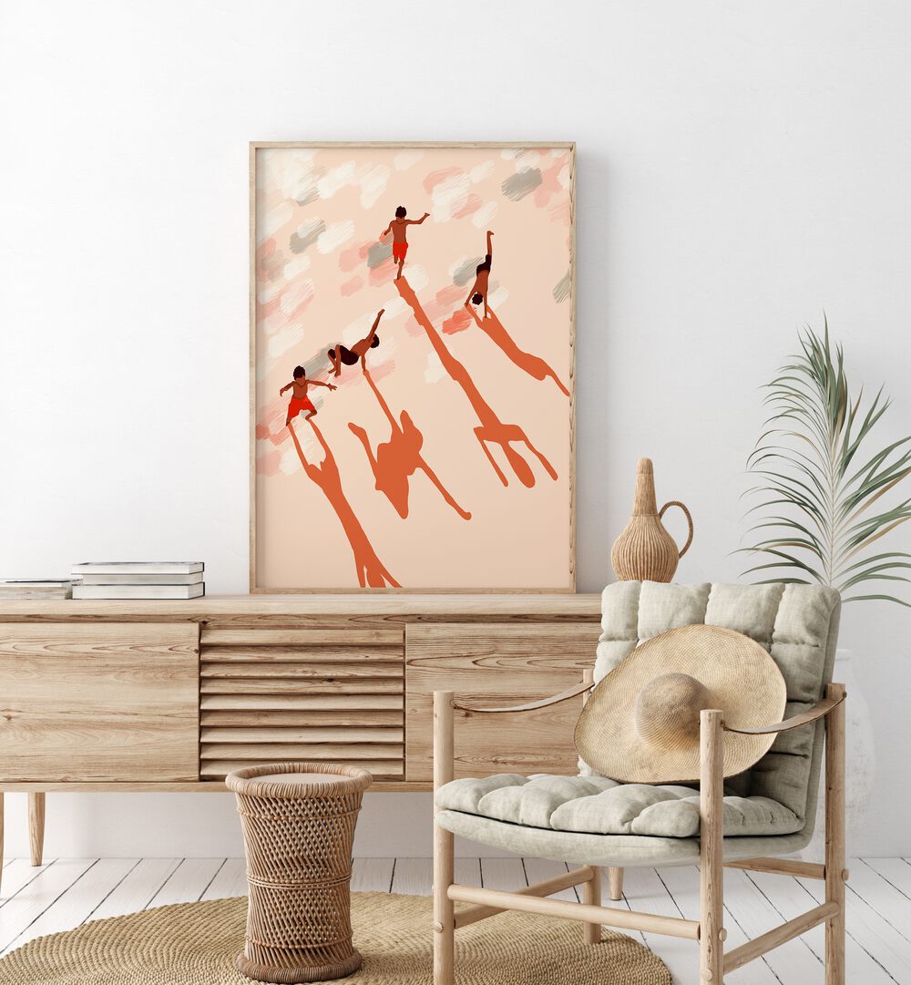 Free Spirits By Uma Gokhale Kids Room Art Prints in Oak Wood Plain Frame on a console table beside a plant