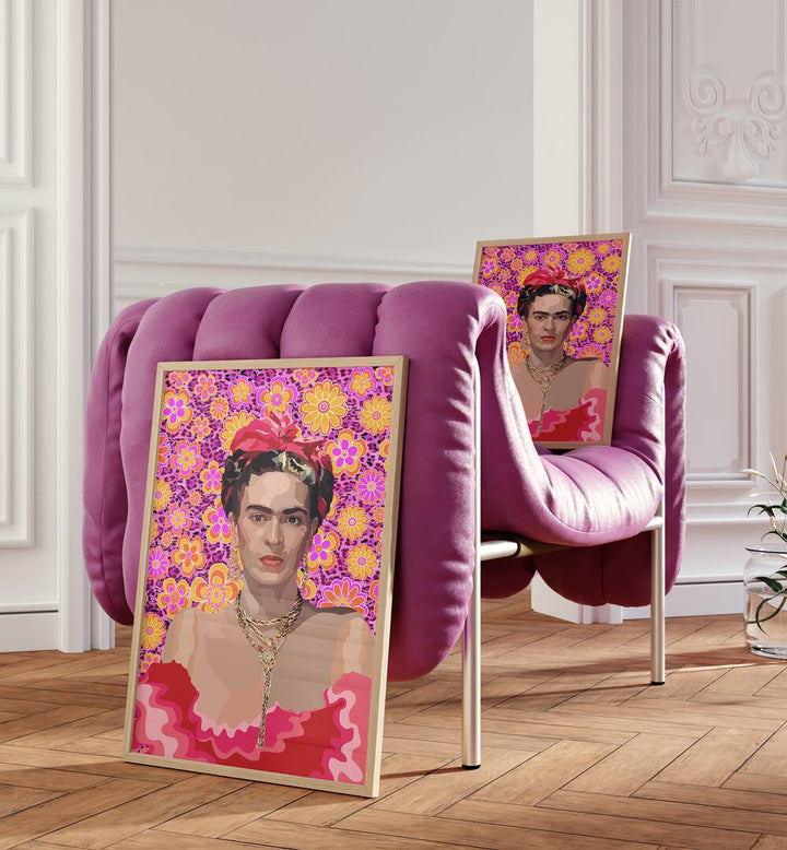 Frida By Lynnda Rakos Pop Art Paintings Pop Art Prints in Oak Wood Plain Frame placed on the floor beside a pink sofa and on the pink sofa