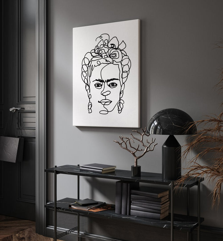 Frida Made Me by Hanna Lee Tidd Line Art Paintings Line Art Prints in Gallery Wrap placed on a wall behind a table and beside a door