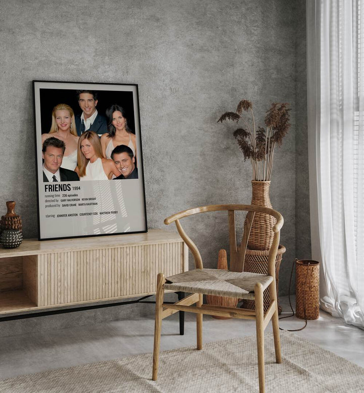 Friends 1994 I Movie Posters in Black Plain Frame placed on a console behind a chair