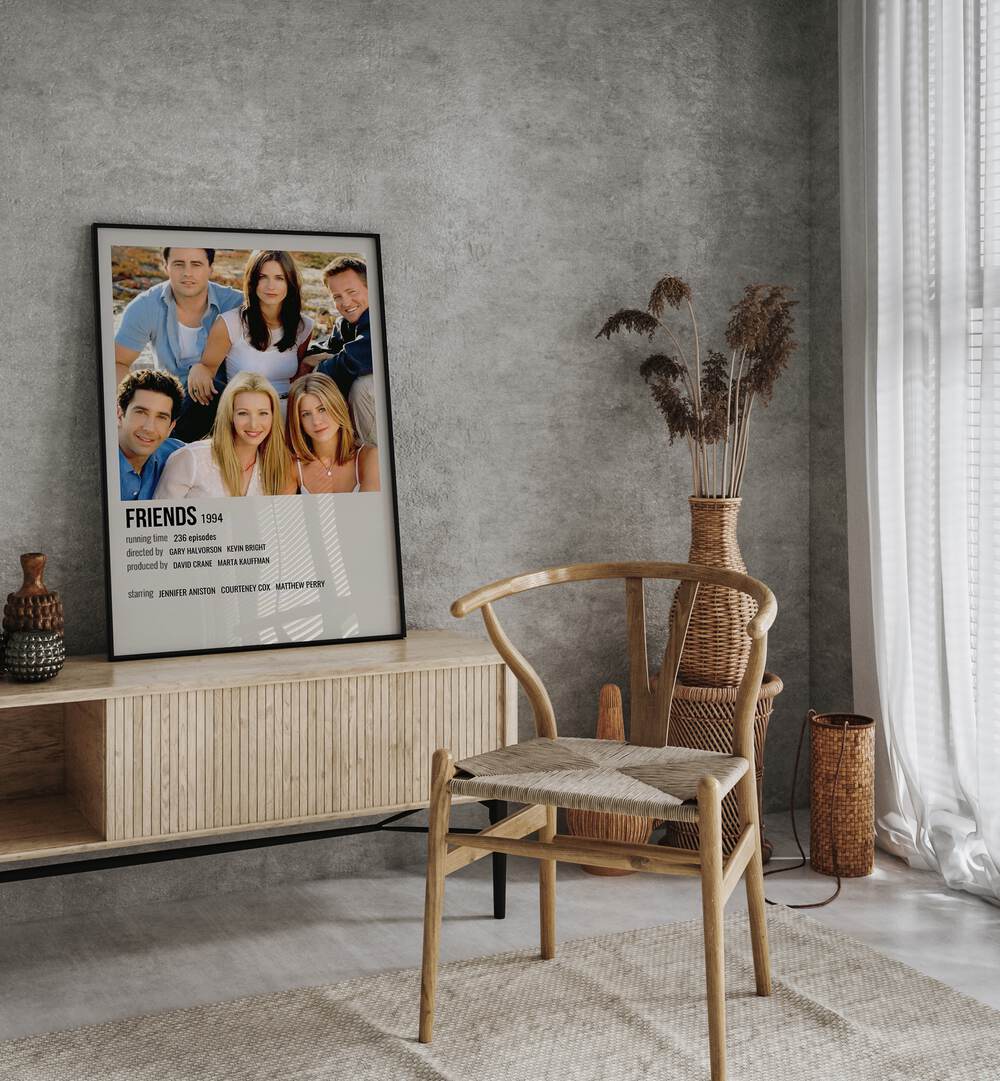 Friends 1994 III Movie Posters in Black Plain Frame placed on a console behind a chair