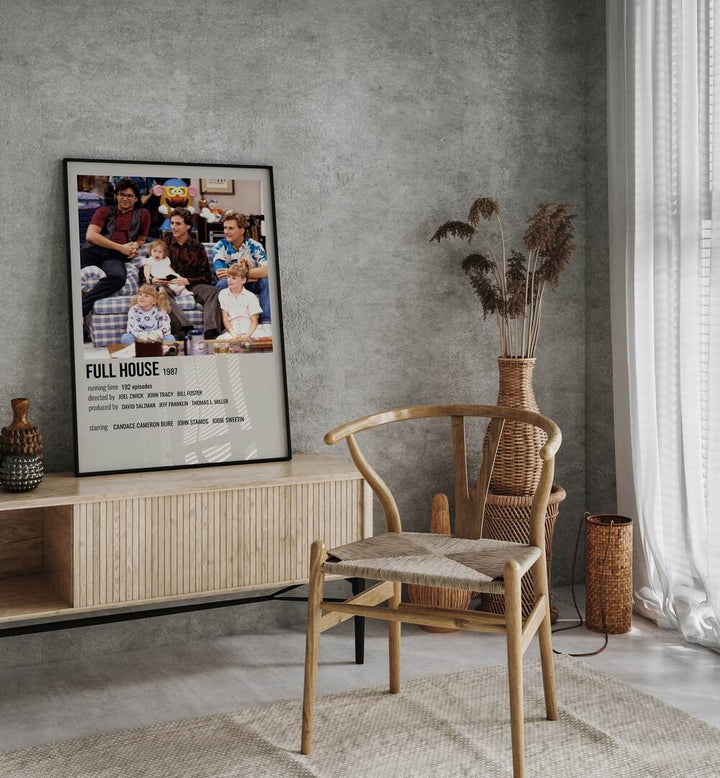 Full House 1987 Movie Posters in Black Plain Frame placed on a console behind a chair