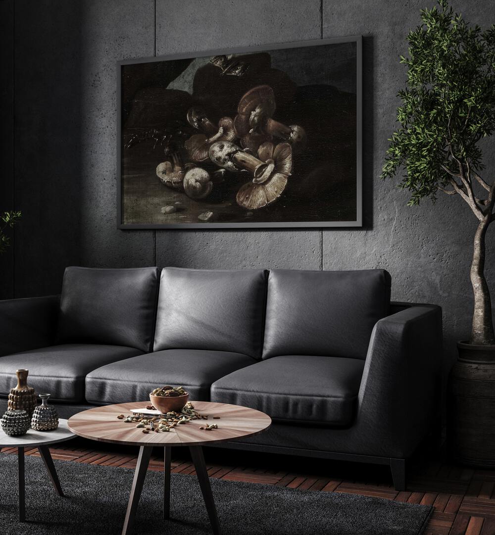 Fungal Phantoms Gothic Wall Art Prints in Black Plain Frame hanging on a wall above black leather couch beside a plant.