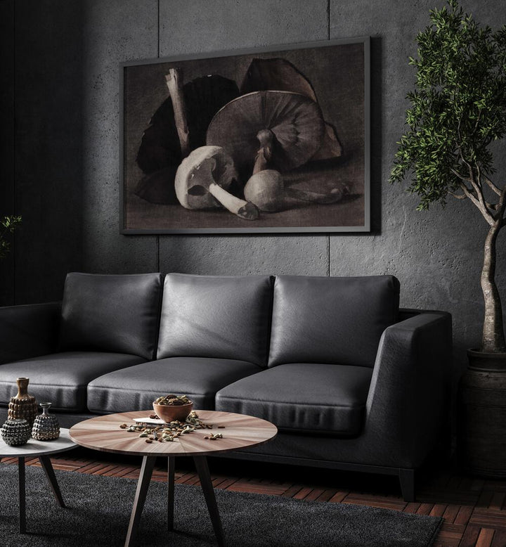 Fungi Dreams Gothic Art Prints in Black Plain Frame hanging on a wall above black leather couch beside a plant.