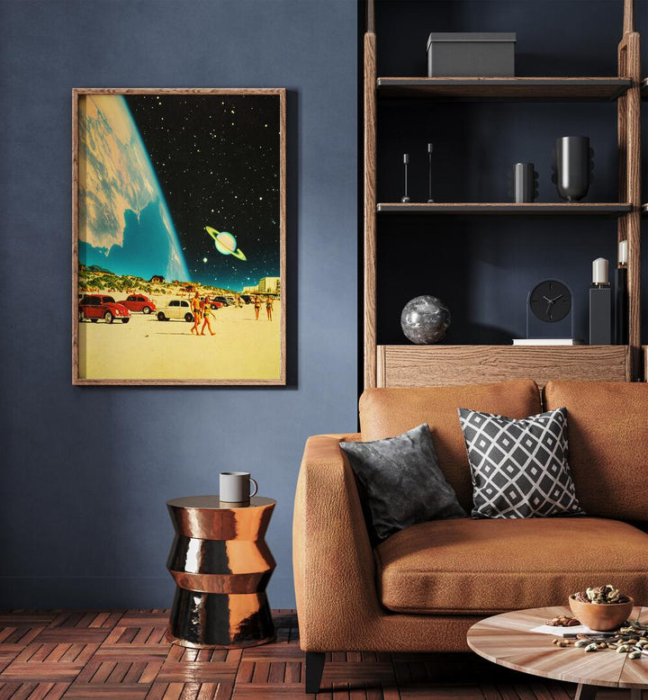 Galaxy Beach By Taudalpoi Astronaut & Nasa Paintings, Space Art Prints Artwork in Oak Wood Plain Frame placed on a Blue Colored Wall near a Brown Sofa in the Living Room



