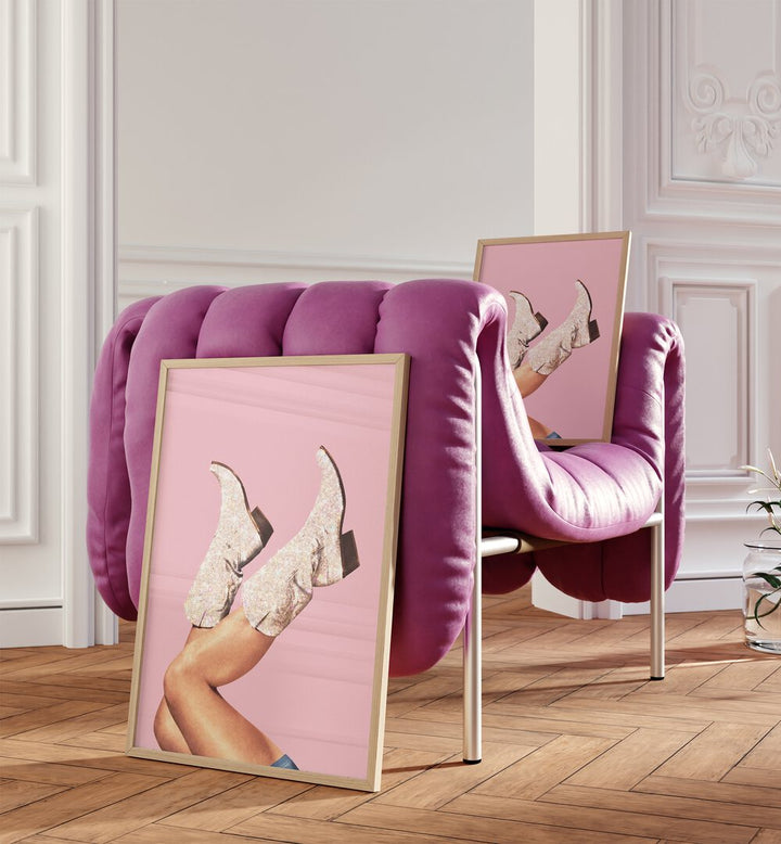 Glitter Boots-pink II Surreal Art Painting Artwork in plain oakwood frame beside a pink sofa and on the sofa