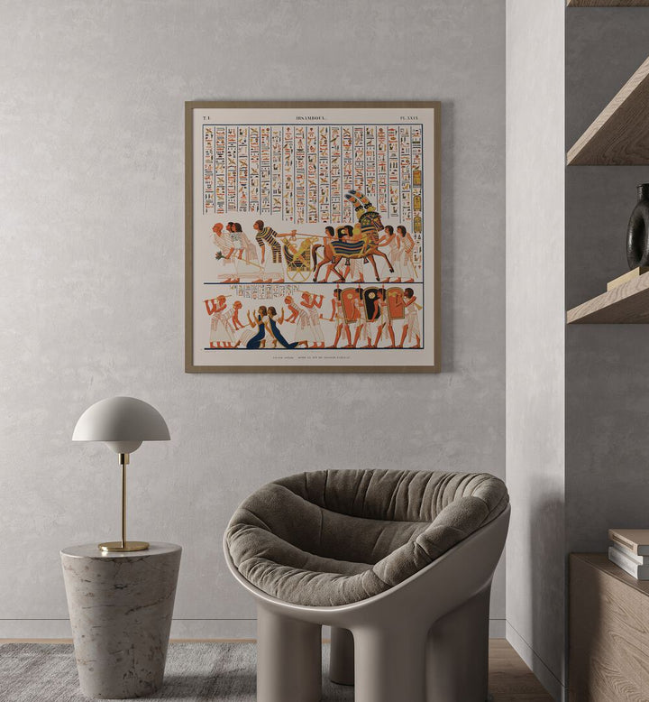 Great Speos Artwork Egyptian Cultural Art Painting Artwork in plain oakwood frame behind a chair on grey colour wall