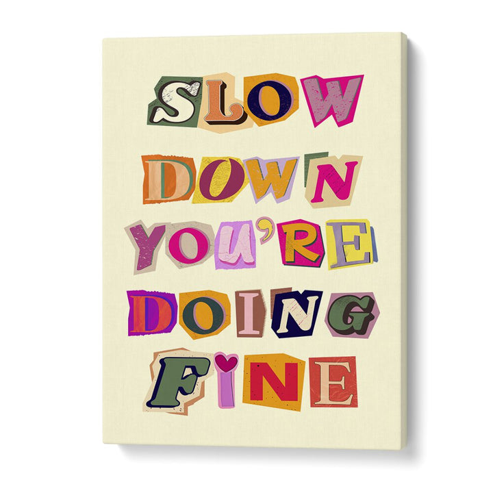 Colorful wall art featuring the phrase "SLOW DOWN YOU'RE DOING FINE" for a cheerful home decor accent.