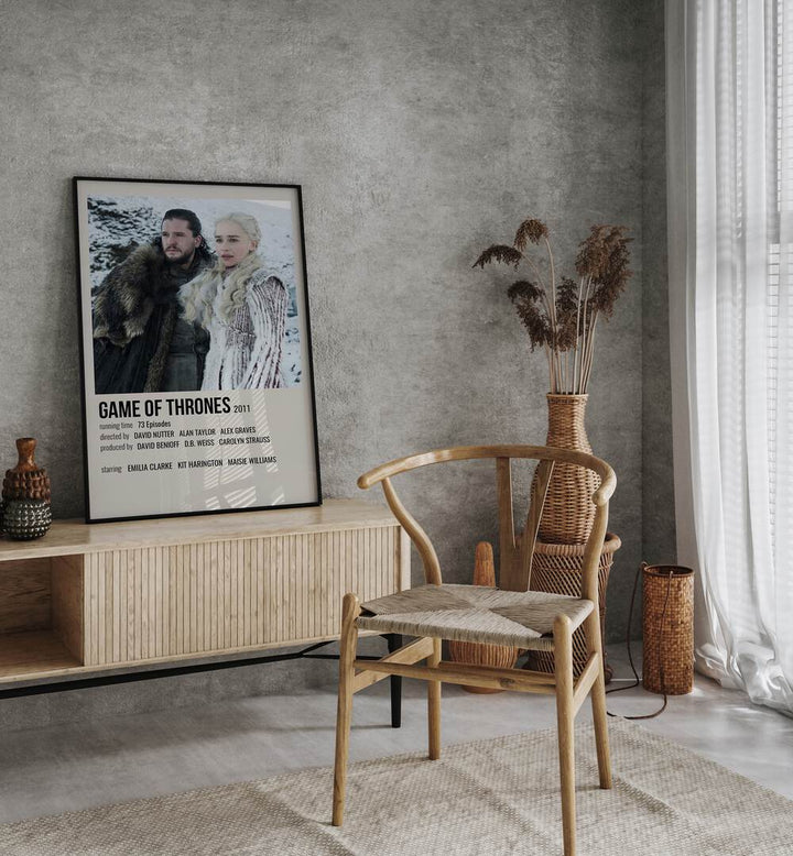 Game Of Thrones 2011 II Movie Posters in Black Plain Frame placed on a console behind a chair