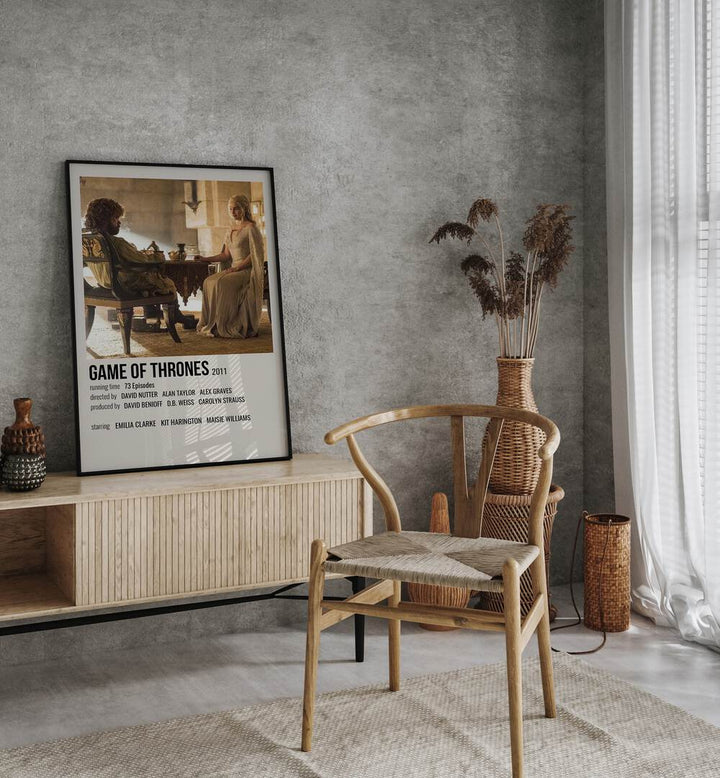 Game Of Thrones 2011 III Movie Posters in Black Plain Frame placed on a console behind a chair