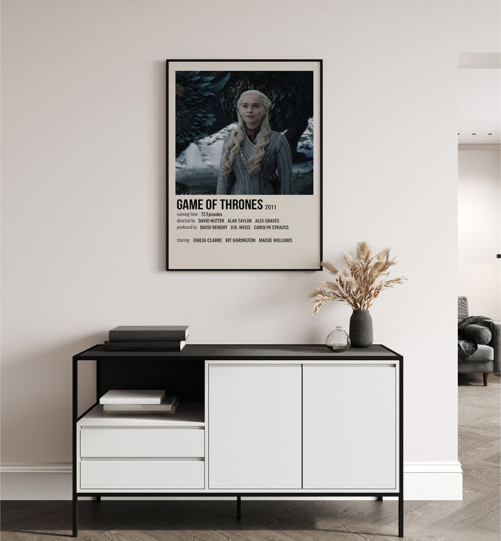 Game Of Thrones 2011 IV Movie Posters in Black Plain Frame placed on a white wall behind a black and white table