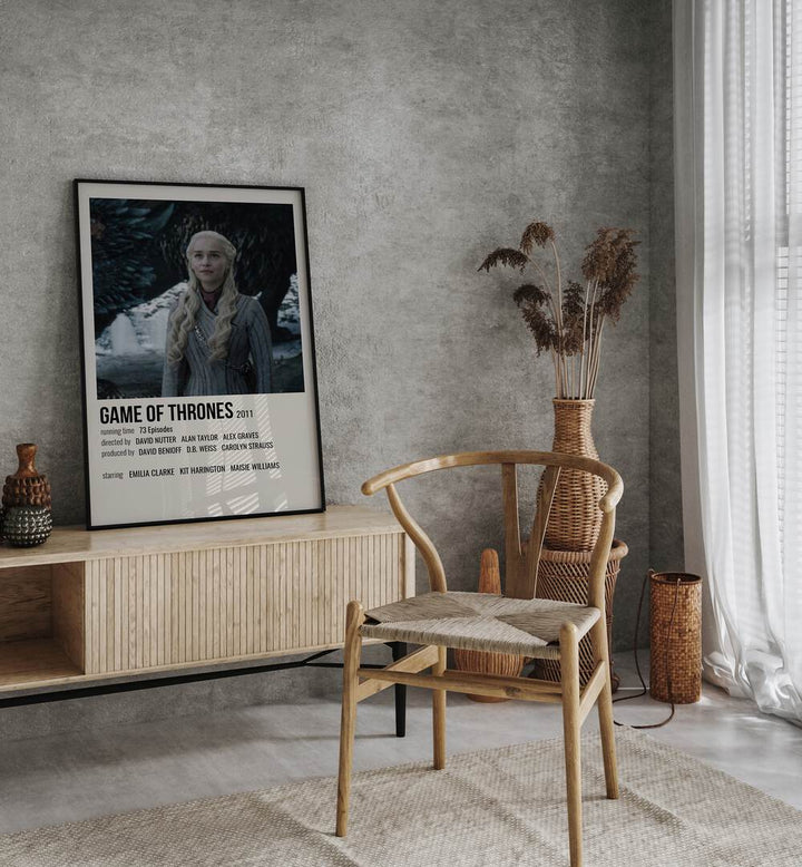 Game Of Thrones 2011 IV Movie Posters in Black Plain Frame placed on a console behind a chair