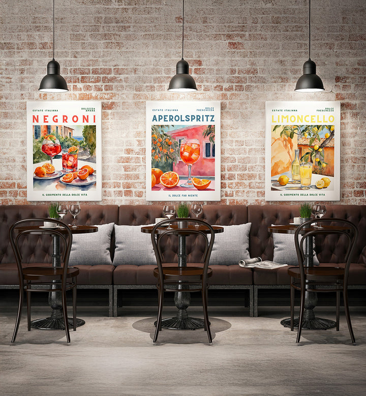Café interior with three cocktail-themed posters on a brick wall.