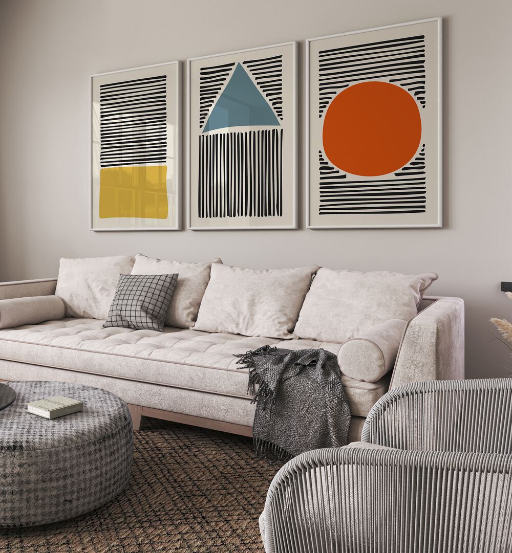 Geo Lines Set Set Of 3 Paintings in White Plain Frame placed on a living room wall behind a sofa