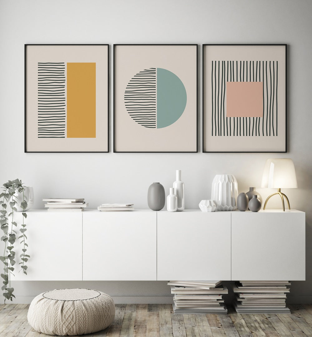 Geometric Duality Set Set Of 3 Paintings in Black Plain Frame placed on a wall behind a console table