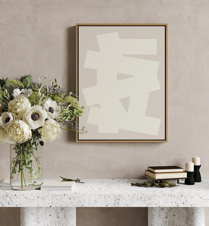 Geometrical Graphic Abstract Art Abstract Paintings in Oak Wood Floater Frame placed on a Beige Colored Wall above a Console Table in the Drawing Room