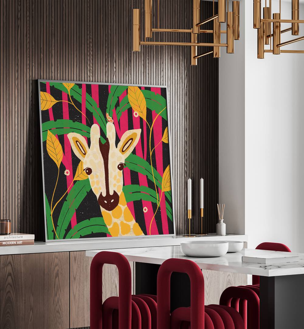 Giraffe-animal Trilogy By Shriya Bhattacharya Kids Paintings in Black Plain Frame in on a console table behind a dining table