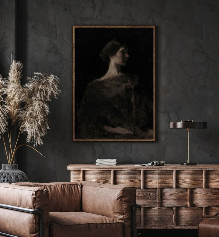 Gloomy-Grace-Gothic-Wall-Art-Prints-in-Oak-Wood-Plain-Frame hanging on wall above brown chair beside plant.