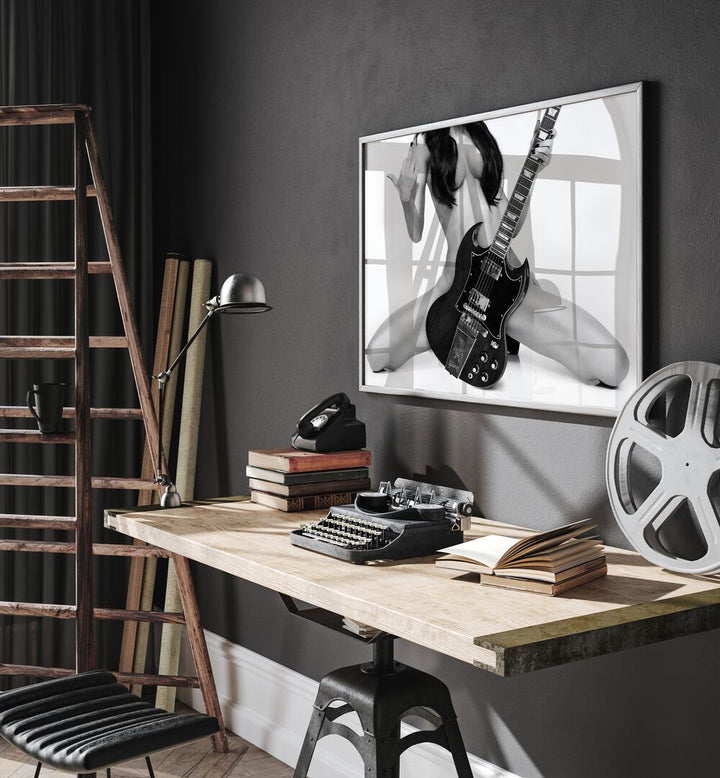 Go Rock Yourself by David Drake Fine Art Photography Fashion Photography in Black Plain Frame placed on a wall behind a study table which is beside a ladder