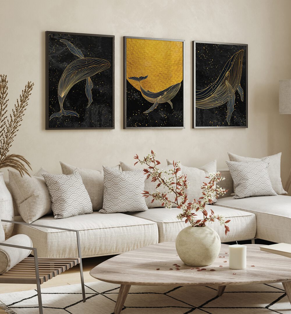 Golden Marina Set Of 3 Paintings in Black Plain Frame placed on a living room wall behind a sofa