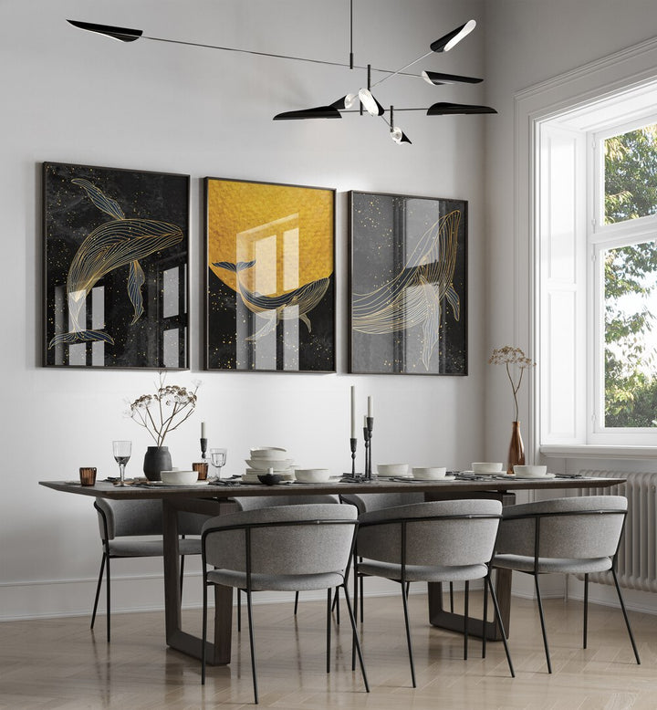 Golden Marina Set Of 3 Paintings in Black Plain Frame placed on a wall behind a dining table and beside a window for dining area