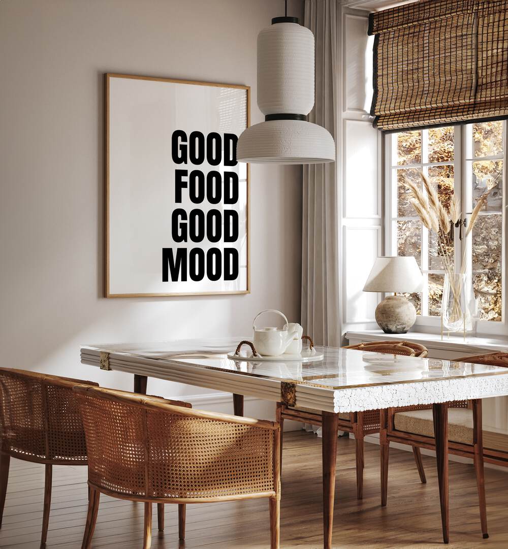 Good Food Good Mood by Athene Fritsch Quotes and Typography Posters in Oak Wood Plain Frame placed on a wall in a dining room area beside a window and behind a dining table