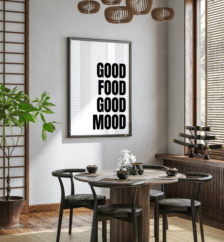 Good Food Good Mood by Athene Fritsch Quotes and Typography Posters in Black Plain Frame placed on a wall in a dining room area beside a window and behind a dining table