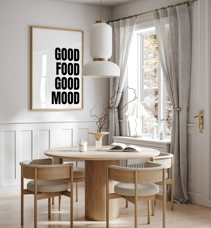 Good Food Good Mood by Athene Fritsch Quotes and Typography Posters in Oak Wood Plain Frame placed on a wall in a dining room area beside a window and behind a dining table