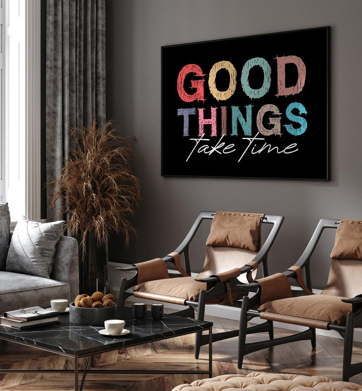 Good Things Quotes and Typography Posters in Black Plain Frame placed on a living room wall behind chairs