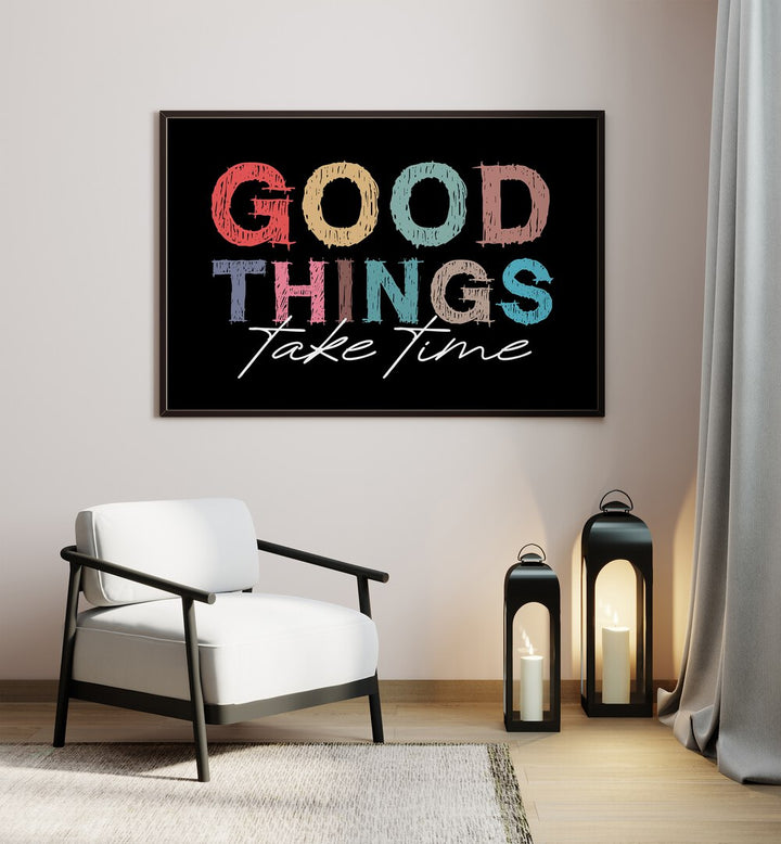 Good Things Quotes and Typography Posters in Black Plain Frame placed on a wall beside a chair