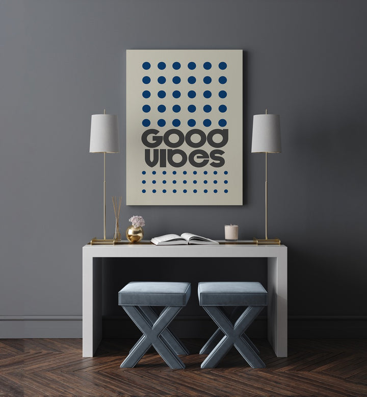 Good Vibes Quotes and Typography Posters in Gallery Wrap placed on a wall between two lamps behind a table