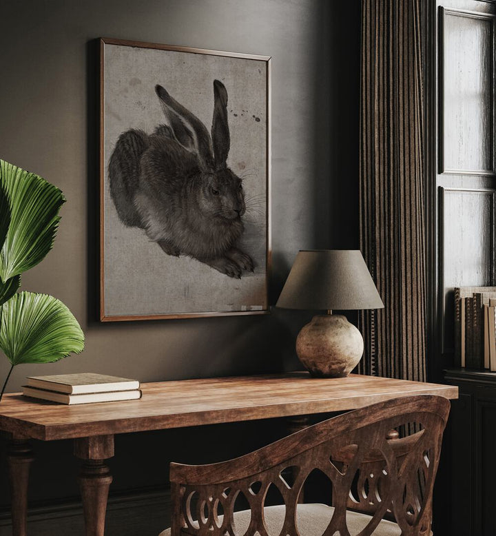 Gothic Hare Shadows In The Warren Gothic Art Prints in Oak Wood Plain Frame hanging on wall above study table beside a window.