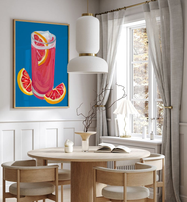 Grapefruit Paloma Blue by Alice Straker Bar Posters Bar Art Prints in Oak Wood Plain Frame placed on a wall in a dining room area beside a window and behind a dining table