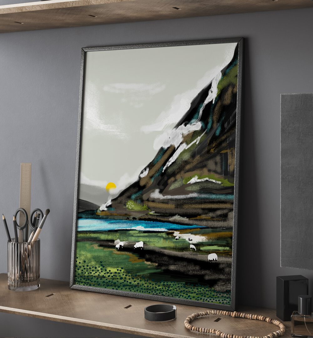 Graze By Uma Gokhale Landscape Paintings in Black Plain Frame on a table beside a pen holder