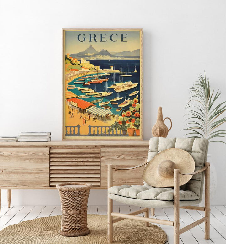 Grece Retro Vintage Travel Travel Posters in Oak Wood Plain Frame on a console table beside a plant