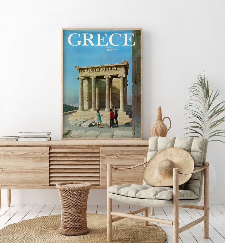 Greece Retro Art I  Vintage Travel Posters in Oak Wood Plain Frame placed on a console table behind chair