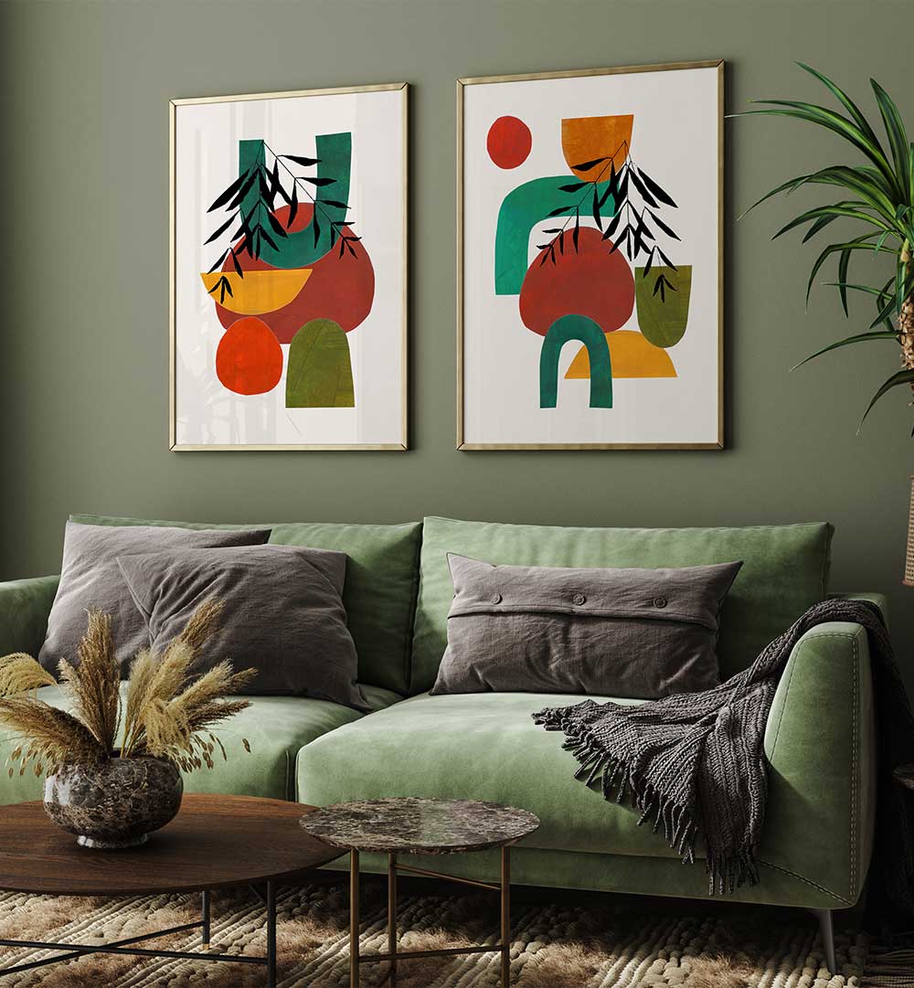 Green sofa with gray pillows in a living room with abstract art on the wall.