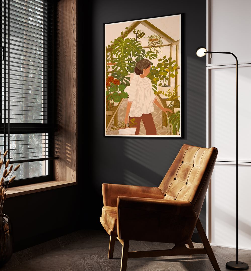 Greenhouse By Andi Bell Botanical Art Prints in Black Plain Frame on a wall placed beside an orange sofa