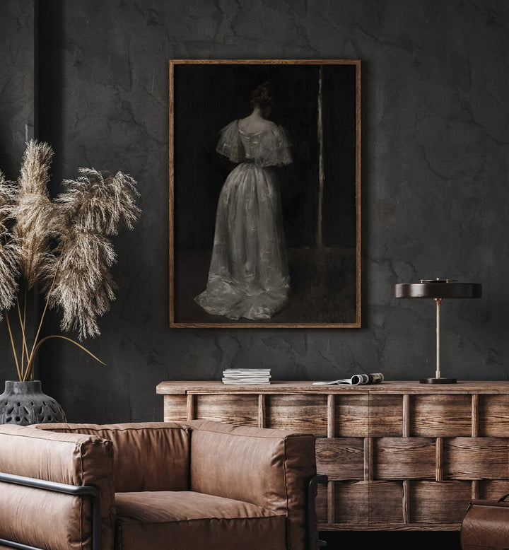 Grief's Silhouette The Weeping Women Gothic Art Prints in Oak Wood Plain Frame hanging on wall above brown chair beside plant.