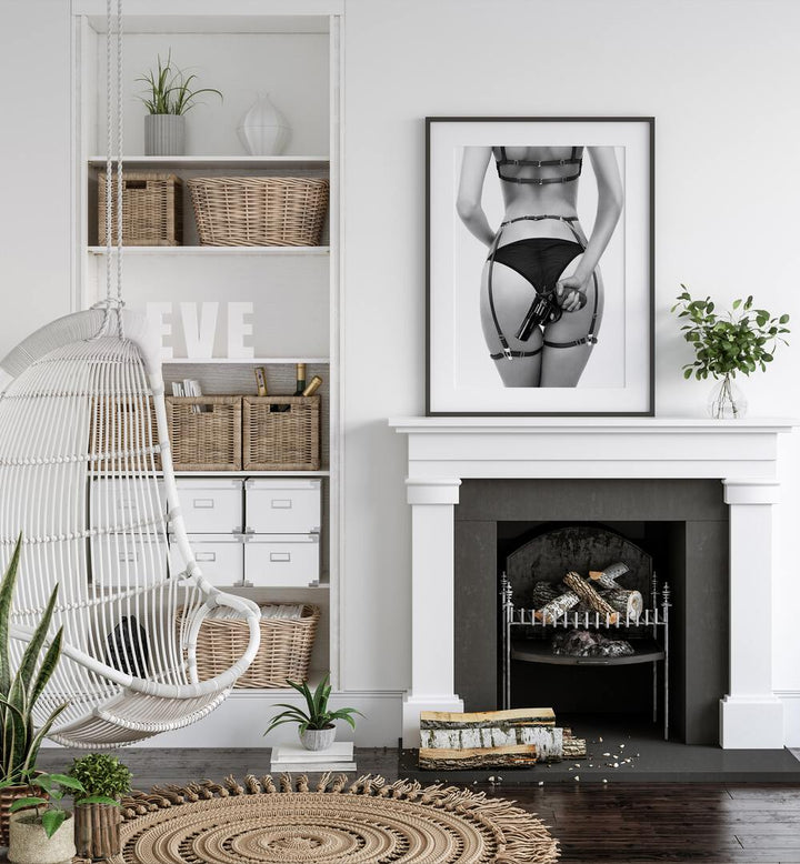 Gun by David Drake Fine Art Photography Fashion Photography in Black Plain Frame placed on a shelf above a hearth beside a plant