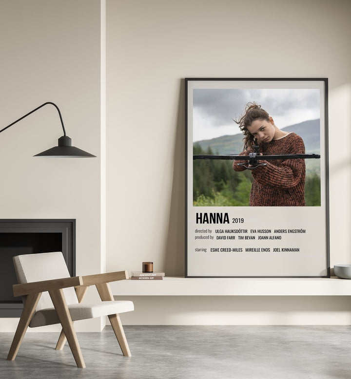 HANNA 2019 MOVIE POSTERS in Black Plain Frame placed on wall beside chair and lamp