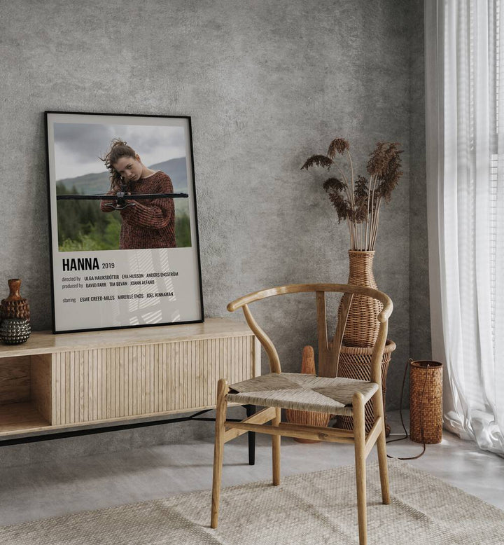 HANNA 2019 MOVIE POSTERS in Black Plain Frame placed on a table beside chair