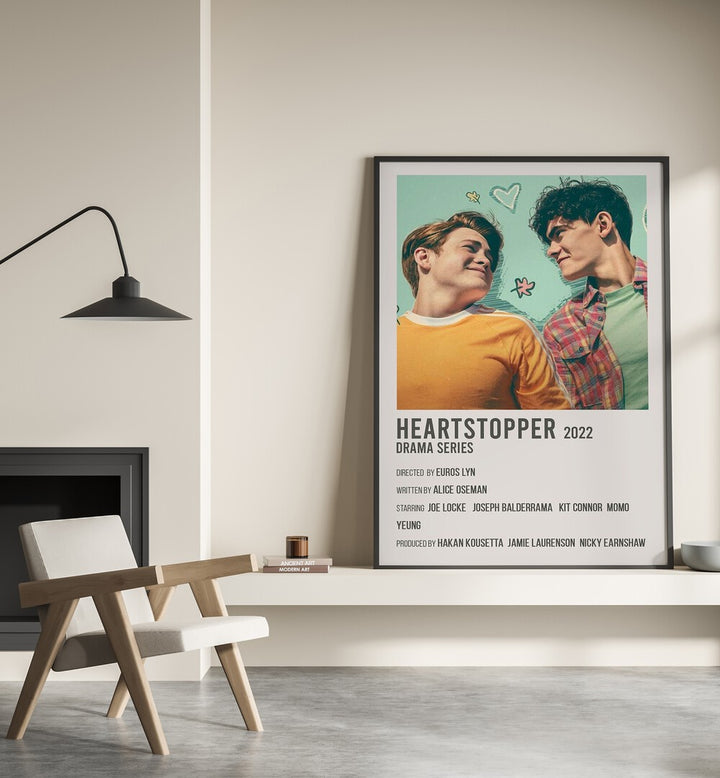 HEARTSTOPPER 2022 MOVIE POSTERS in Black Plain Frame placed on wall beside chair and lamp