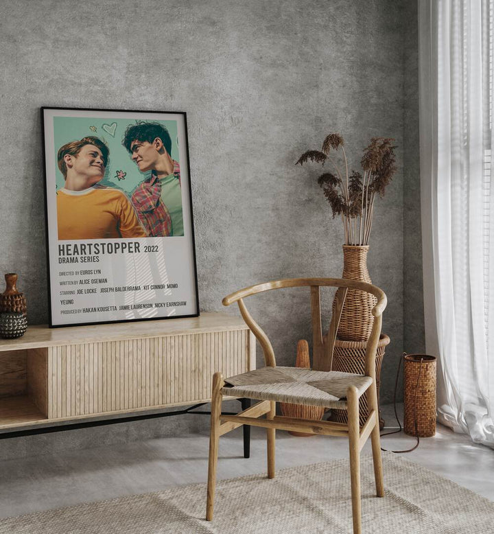 HEARTSTOPPER 2022 MOVIE POSTERS in Black Plain Frame placed on a table beside chair