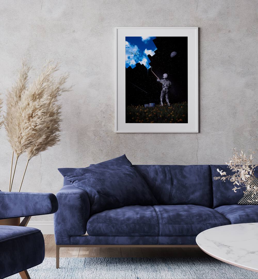 Hello Blue Sky By Francis Minoza Astronaut & Nasa Paintings, Space Art Prints Artwork in White Frame With Mount placed on a Grey Colored Wall near a Blue Sofa in the Living Room
