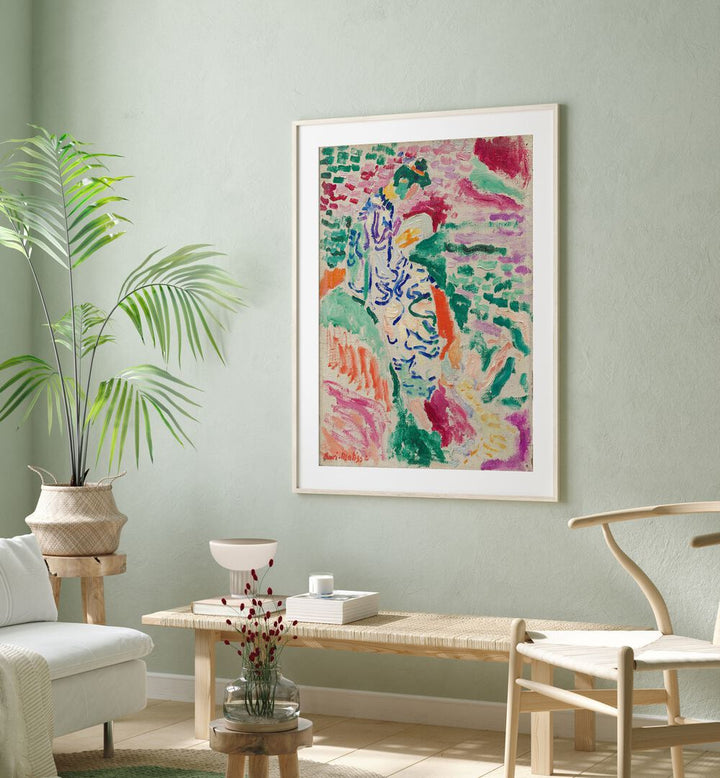 Henri Matisse's 'la Japonaise Vintage Art Painting Artwork in white frame with mount above a ottoman beside a plant on a green wall