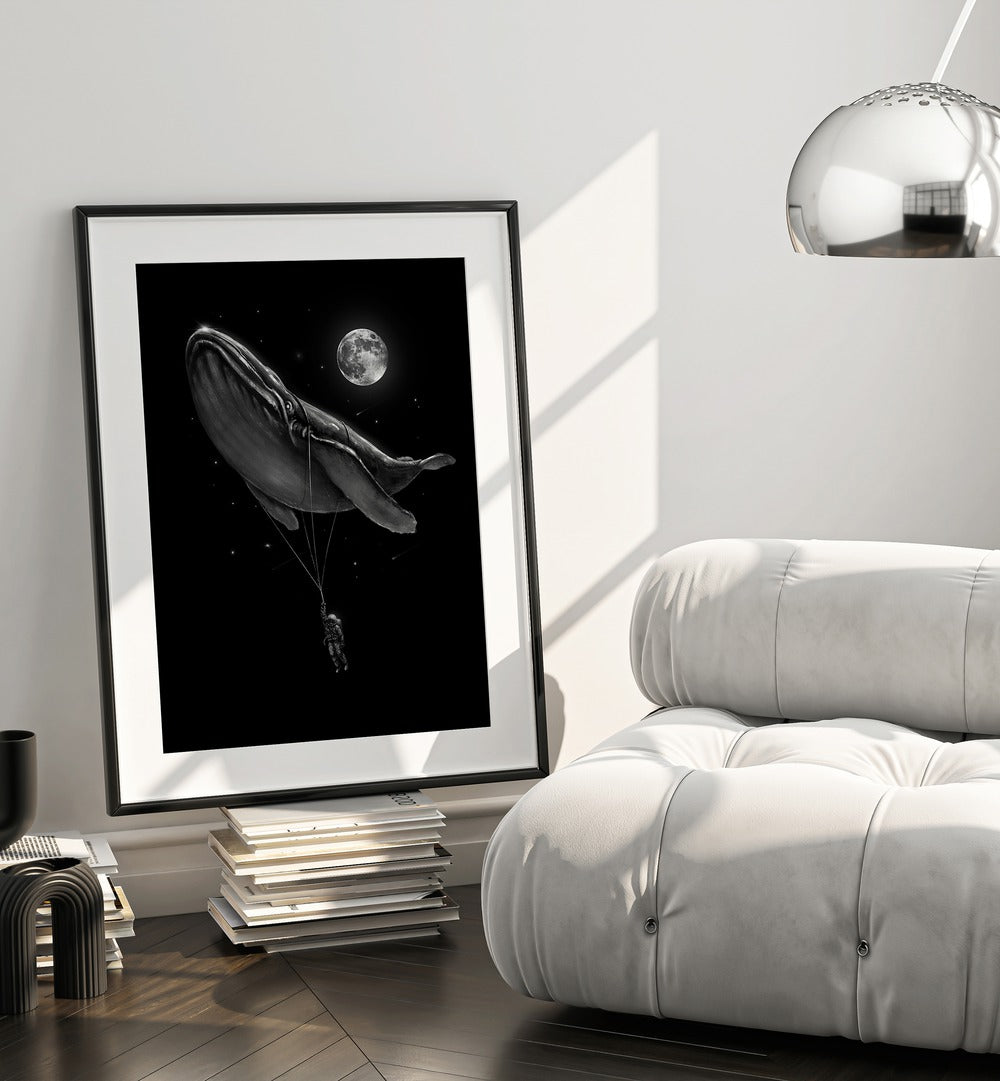 Hitching A Ride By Francis Minoza Astronaut & Nasa Paintings, Space Art Prints Artwork in Black Frame With Mount placed near a White Sofa in the Living Room